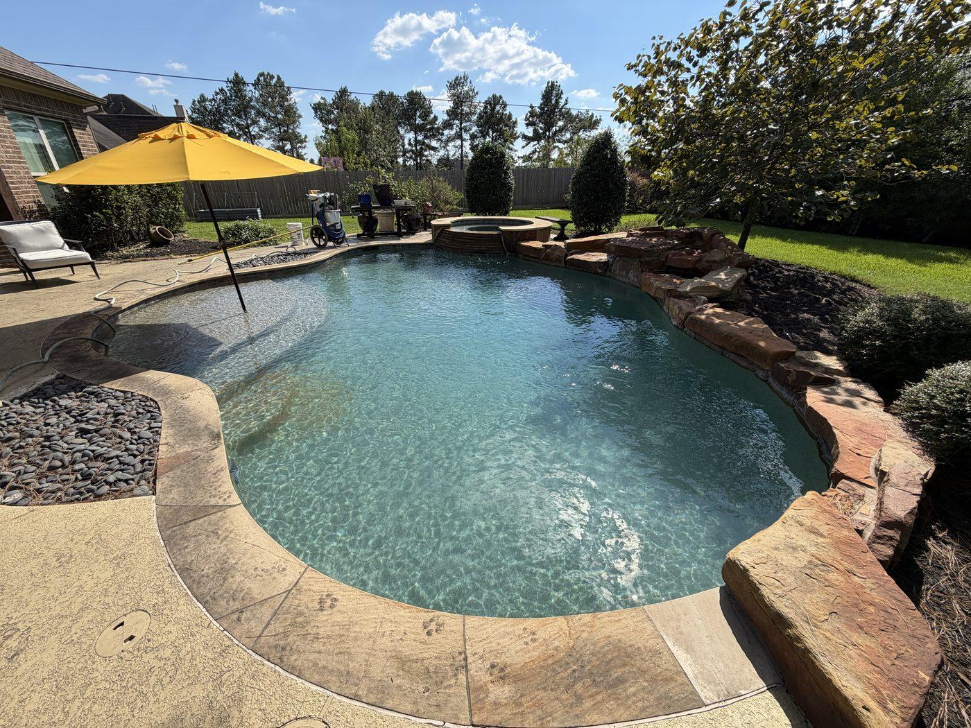 Customer pool with a rock waterfall and spa